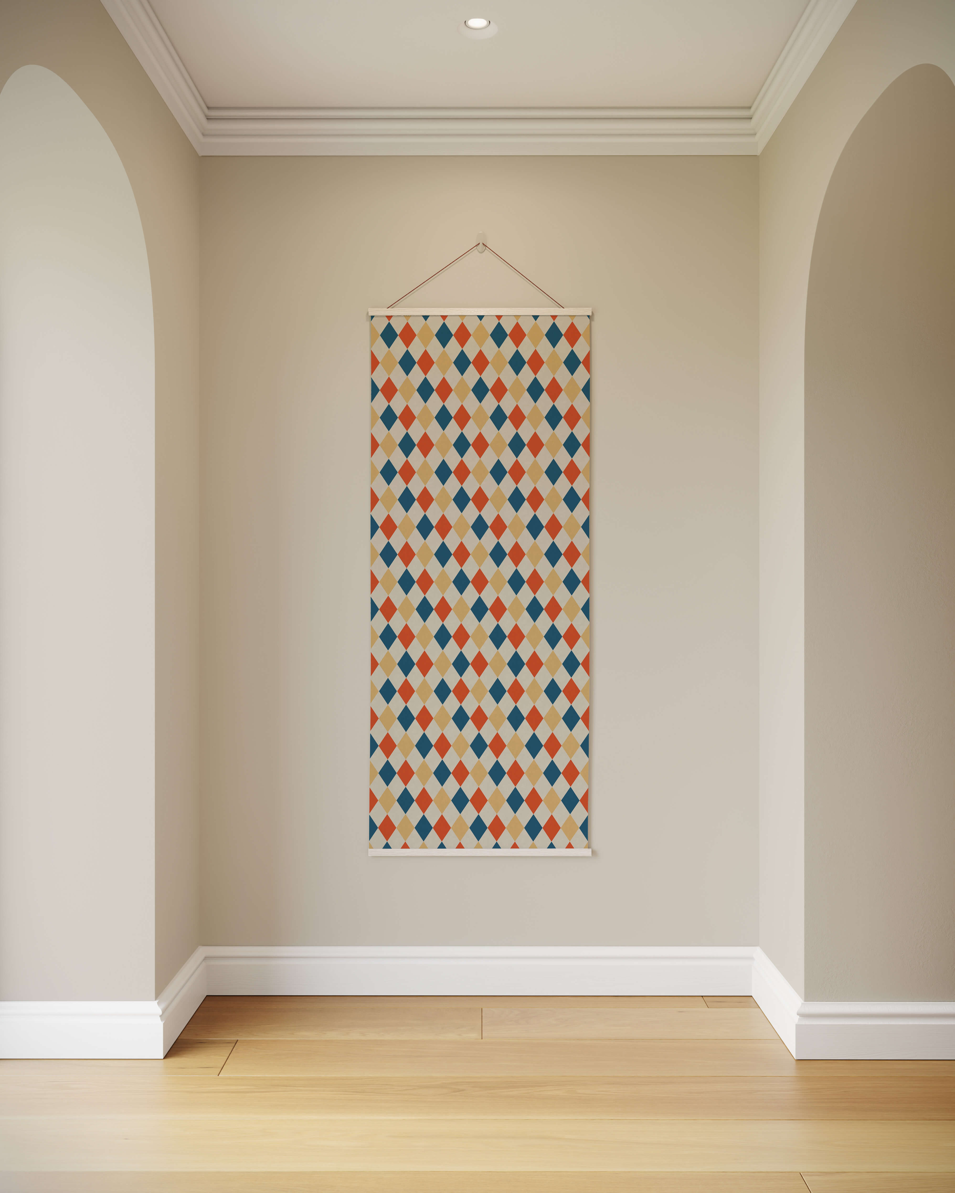 A rectangular harlequin pattern tapestry with orange blue and beige diamonds on a cream background wall hanging