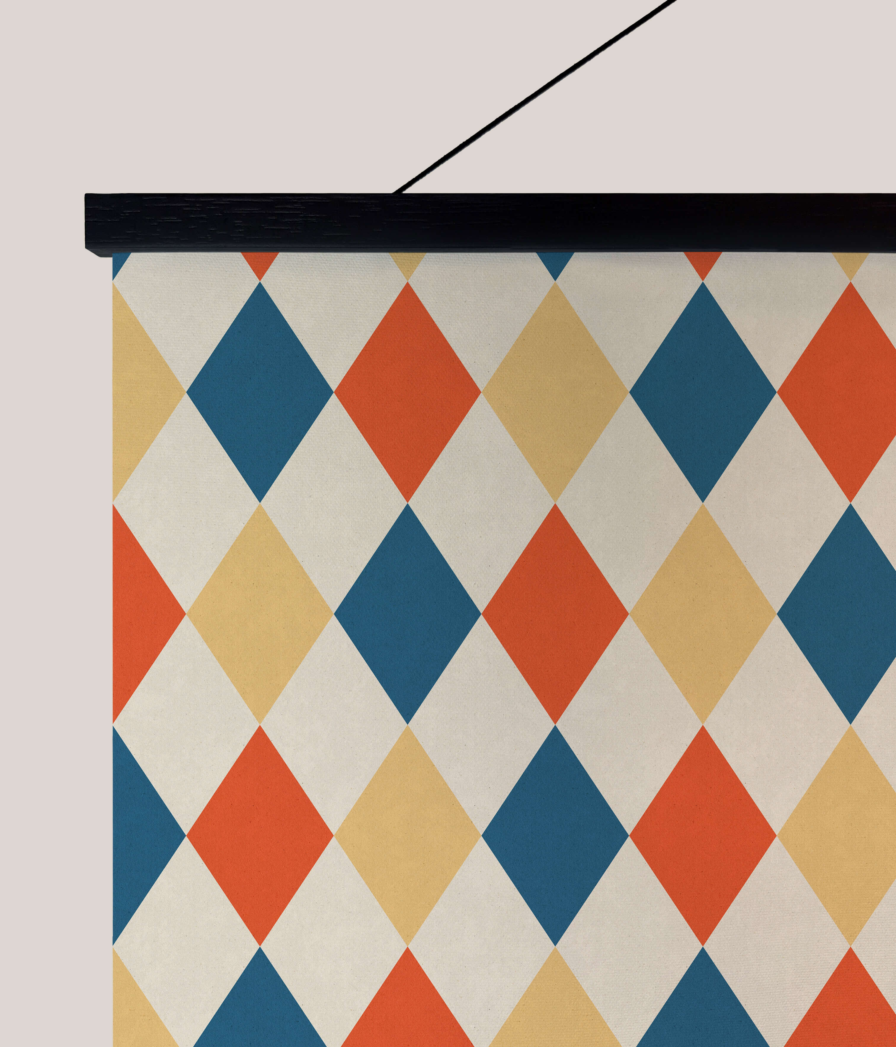 A vibrant harlequin pattern tapestry with bold orange navy blue and cream geometric shapes for wall decor