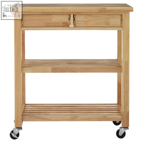 Light-colored hevea wood kitchen trolley with top drawer and two open shelves on black caster wheels by harlow glenn