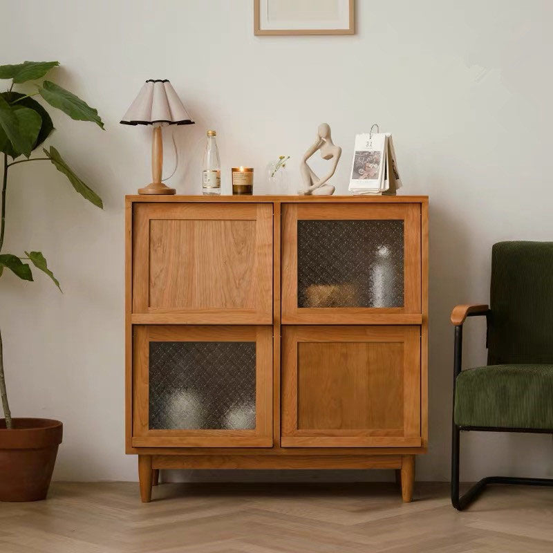 Light brown solid wood harriet sideboard with two upper doors and two lower doors including a textured glass panel