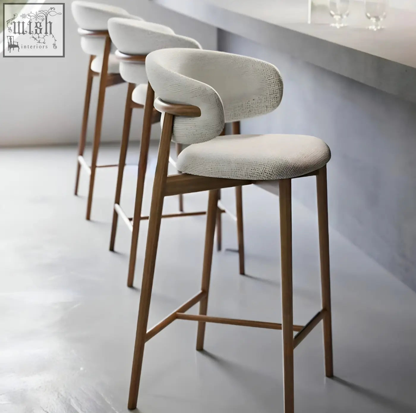 Modern haruto bar stool with light beige upholstered seat and curved wooden frame perfect for home bars
