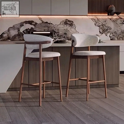 Modern haruto bar stool with upholstered white seats and backrests and sleek wooden legs for stylish seating