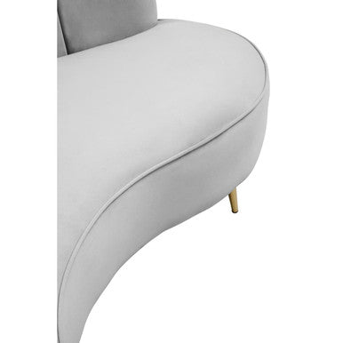 A sleek hasna three seat grey velvet sofa with light gray upholstery and gold-tone slender legs