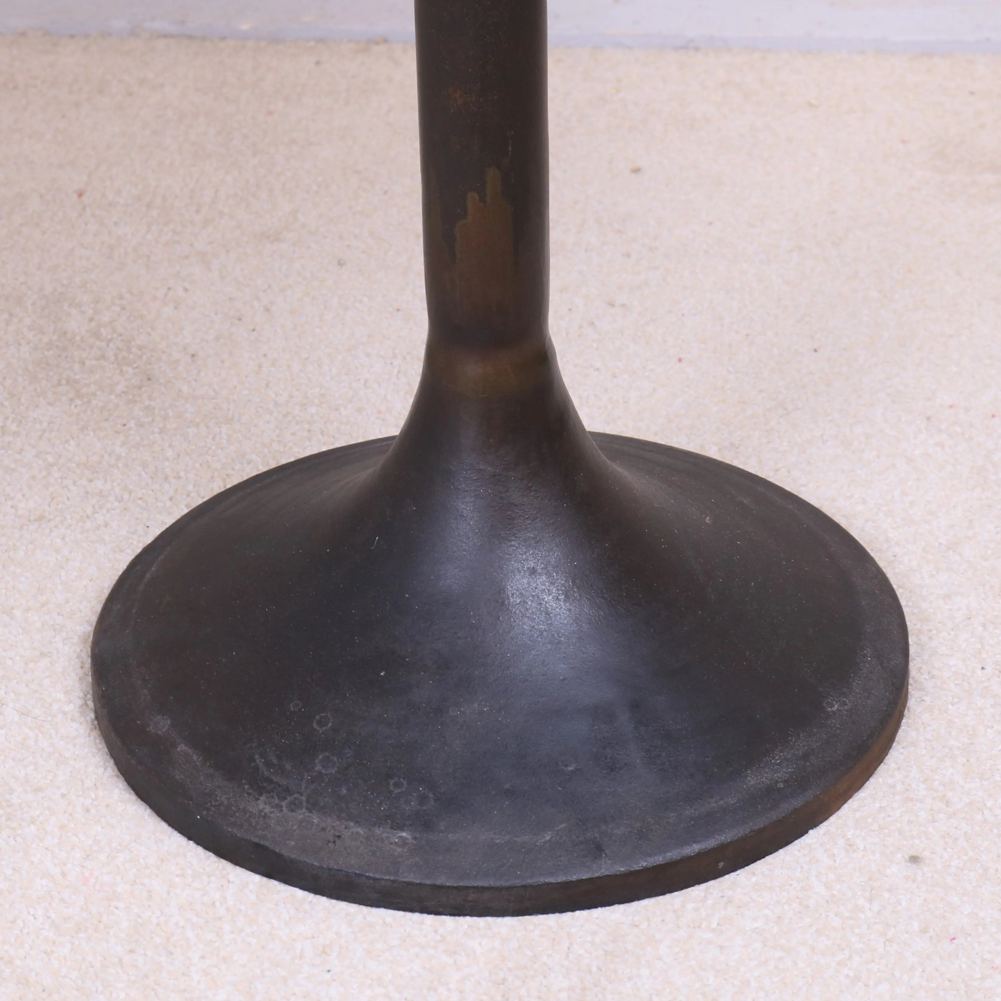 Dark bronze metal table base with flared circular foot and slim stem for hatra industrial style side table