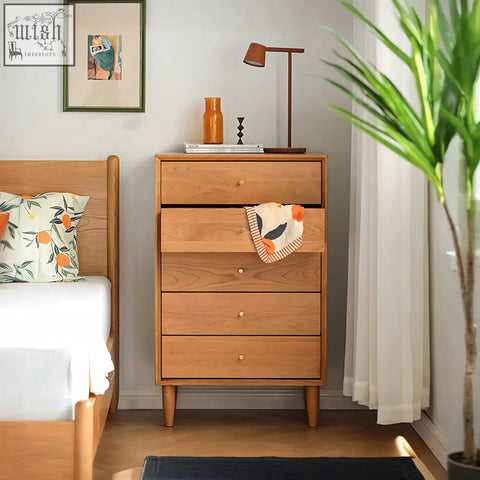 Light brown solid wood hazel cabinet with four drawers and small brass knobs cleaned with a damp cloth
