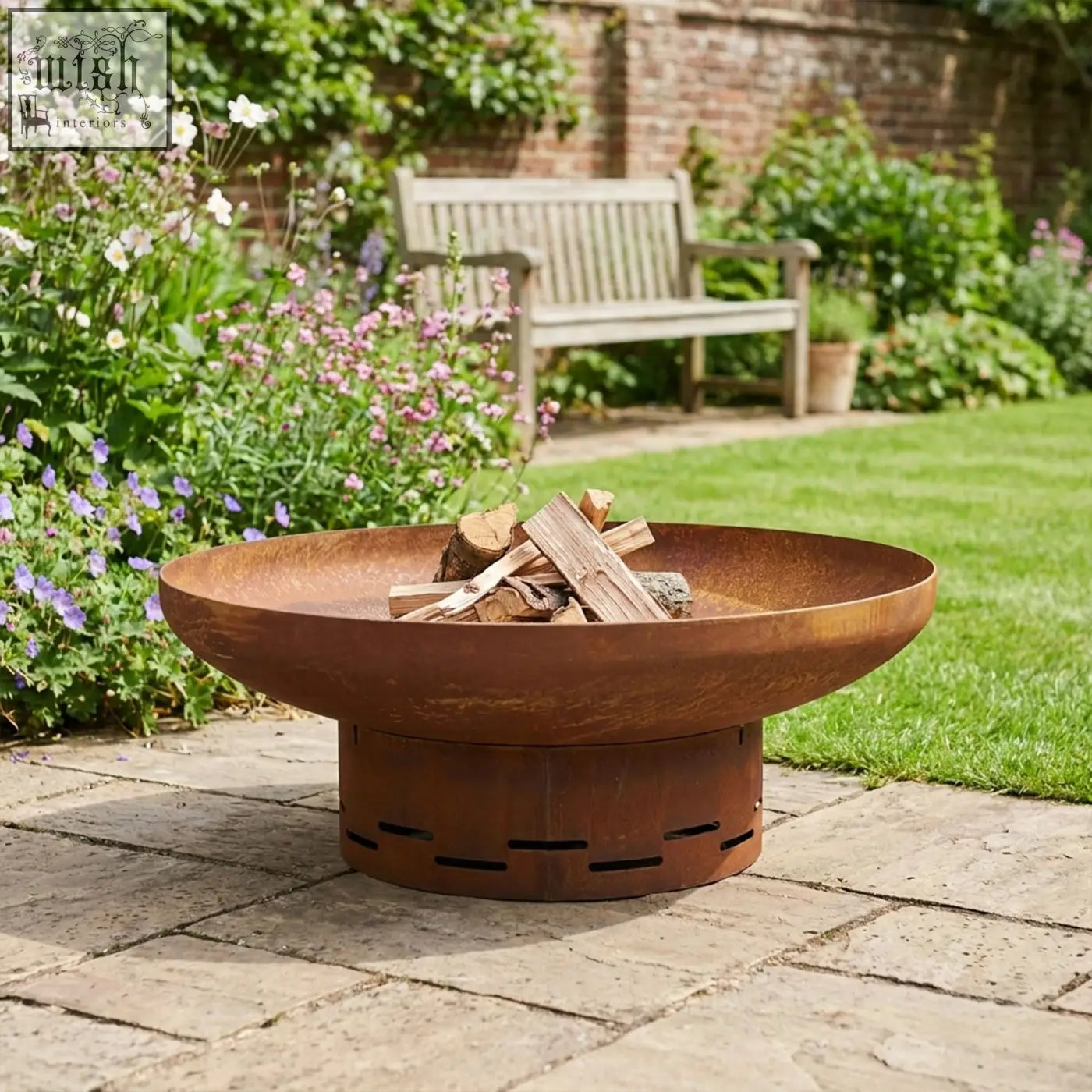Rustic copper-colored corten steel nicoman heavy-duty pre-rusted corten steel round firepit with stacked logs and perforated base