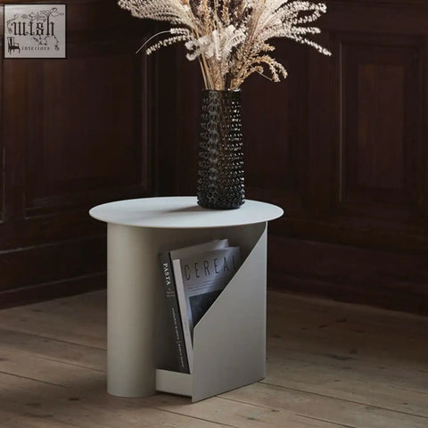 Matte white hector side table with painted steel base and integrated book storage for magazines and books