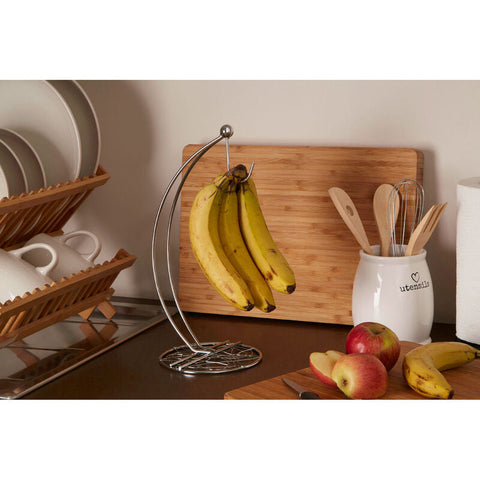 A sleek chrome finish banana hanger with a curved stainless steel hook and circular base for hanging bananas
