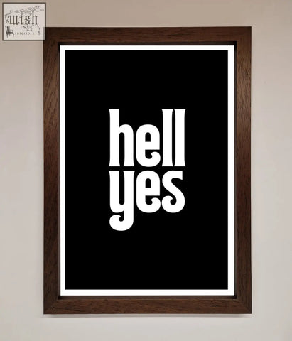A framed print featuring bold black and white hell yes text in a dark brown wooden frame offering stylish frame choices