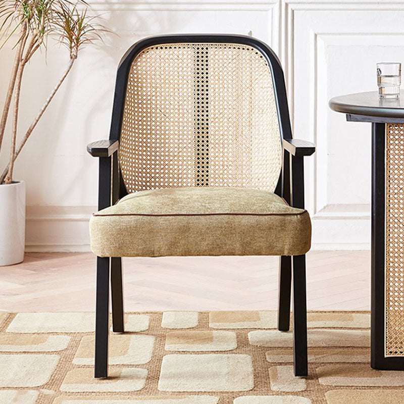 Black-framed hellen rattan dining chair with woven cane back and beige cotton linen seat in ash wood finish