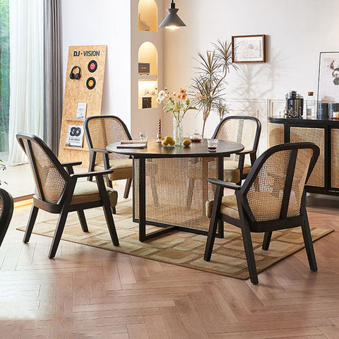 Black-framed hellen rattan dining chair with woven natural-toned backrest and cotton linen upholstered seat