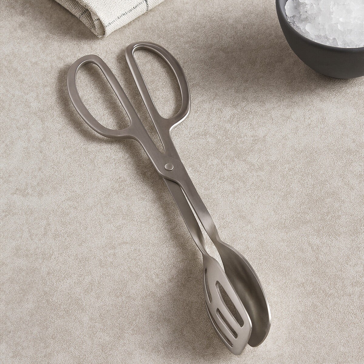 Hera brushed stainless steel tongs with slotted ends and a sleek modern design for easy food handling