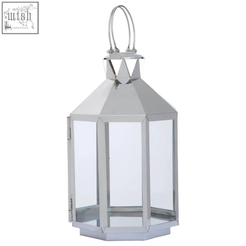 Herber large silver steel lantern with a hexagonal base clear glass panels and sleek silver metal frame