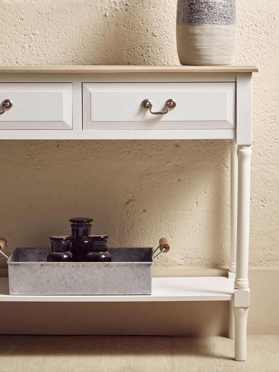 Heritage white rectangular console table with two drawers and turned legs topped by a speckled ceramic vase