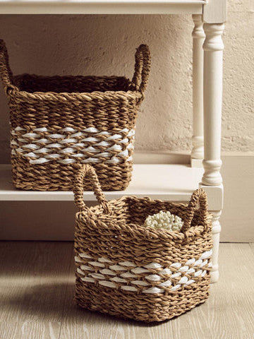 Natural woven wicker basket with white stripe and handles displayed under drawers white console table heritage 3 drawers white console