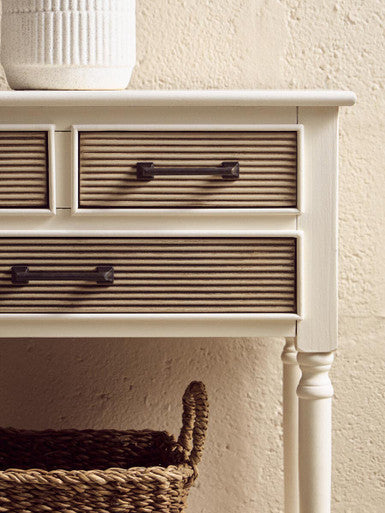 Heritage white console table with three drawers featuring woven rattan fronts and dark metal handles drawers white console