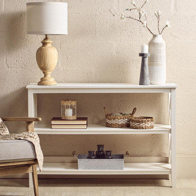 Heritage three shelf large white wooden console table with three shelves holding a lamp and woven baskets