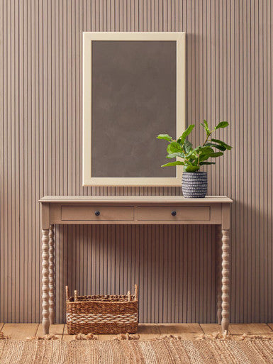 Beige wooden heritage two drawer desk with turned legs and matching framed mirror in natural wash finish