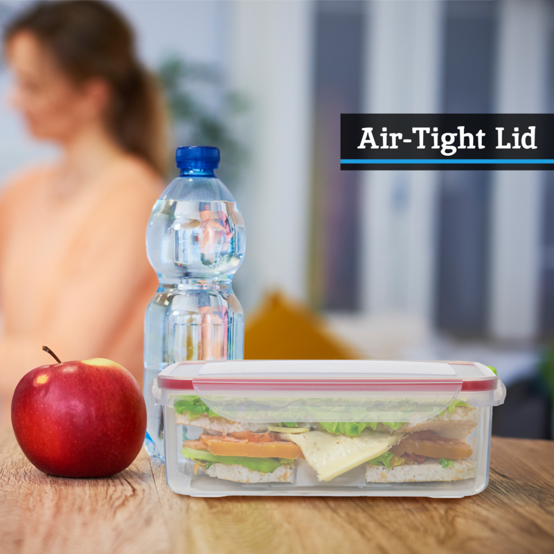 Clear plastic square food container with white airtight lid and red seal holding layered sandwiches from herrela set
