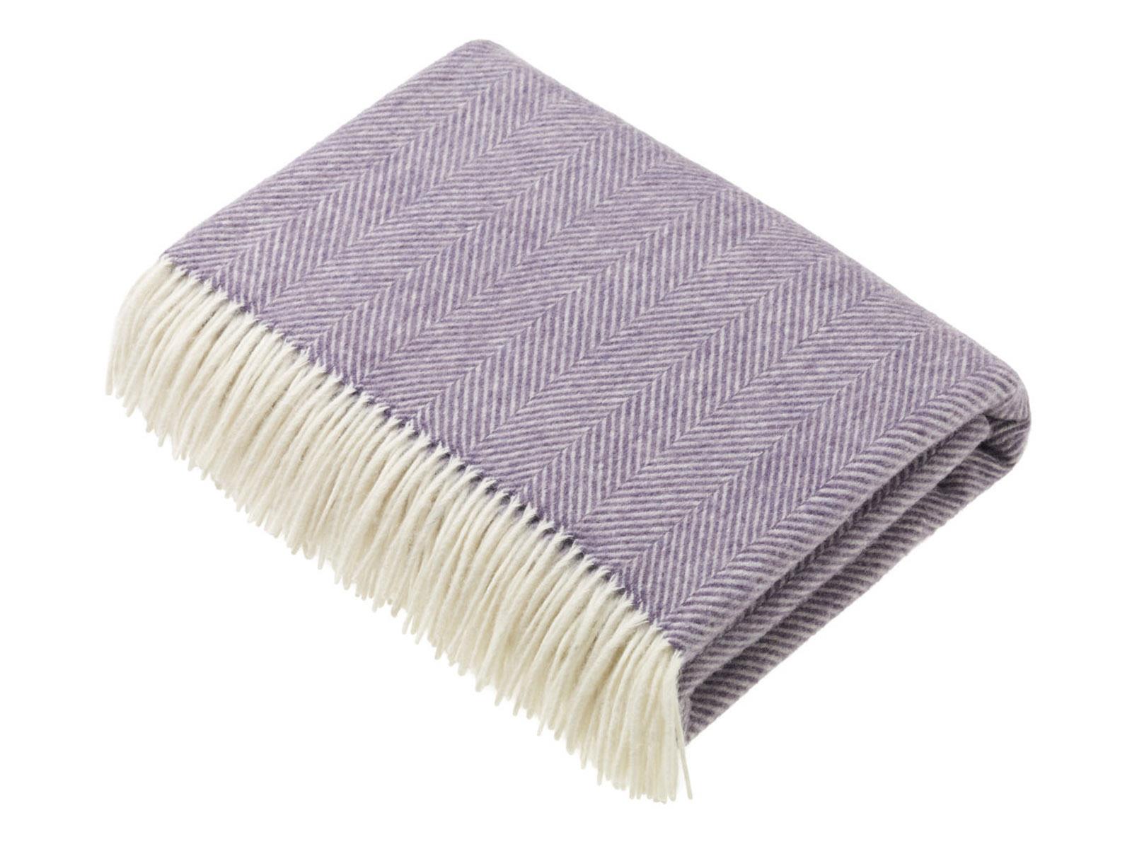 A soft lavender herringbone merino lambswool throw with cream fringe perfect for cozy home use