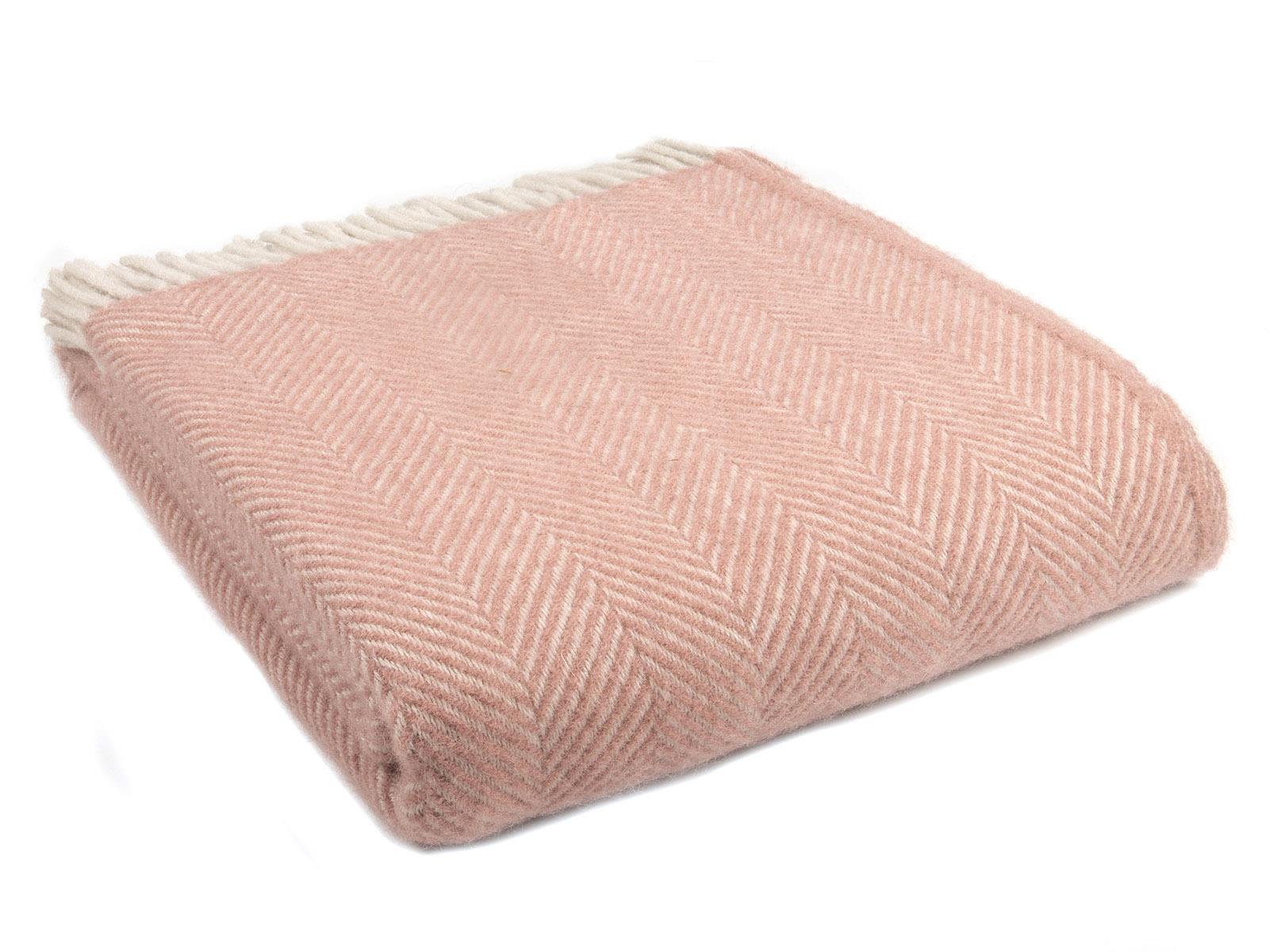 A soft dusky pink pearl herringbone pure new wool throw with cream fringe perfect for cozying up