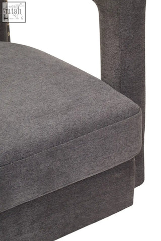 Dark gray hestia ash velvet swivel chair with textured fabric and subtle nailhead trim on the armrest