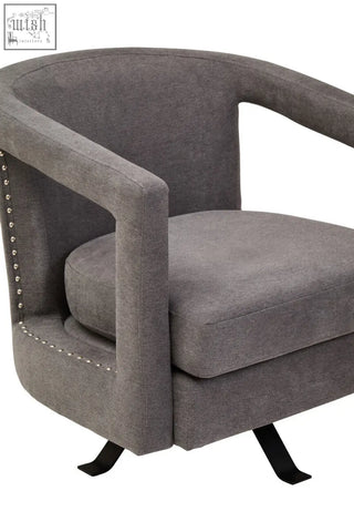 Gray upholstered hestia ash velvet swivel chair with studded detailing and black metal legs for stylish seating