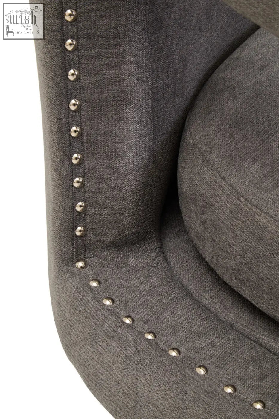 Gray upholstered hestia ash velvet swivel chair with silver nailhead trim along the edges
