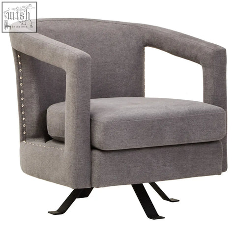 Gray upholstered hestia ash velvet swivel chair with studded accents and black metal base for stylish seating
