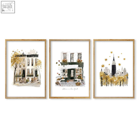 Set of three framed watercolor travel wall art prints featuring autumn new york cityscapes in light wood frames