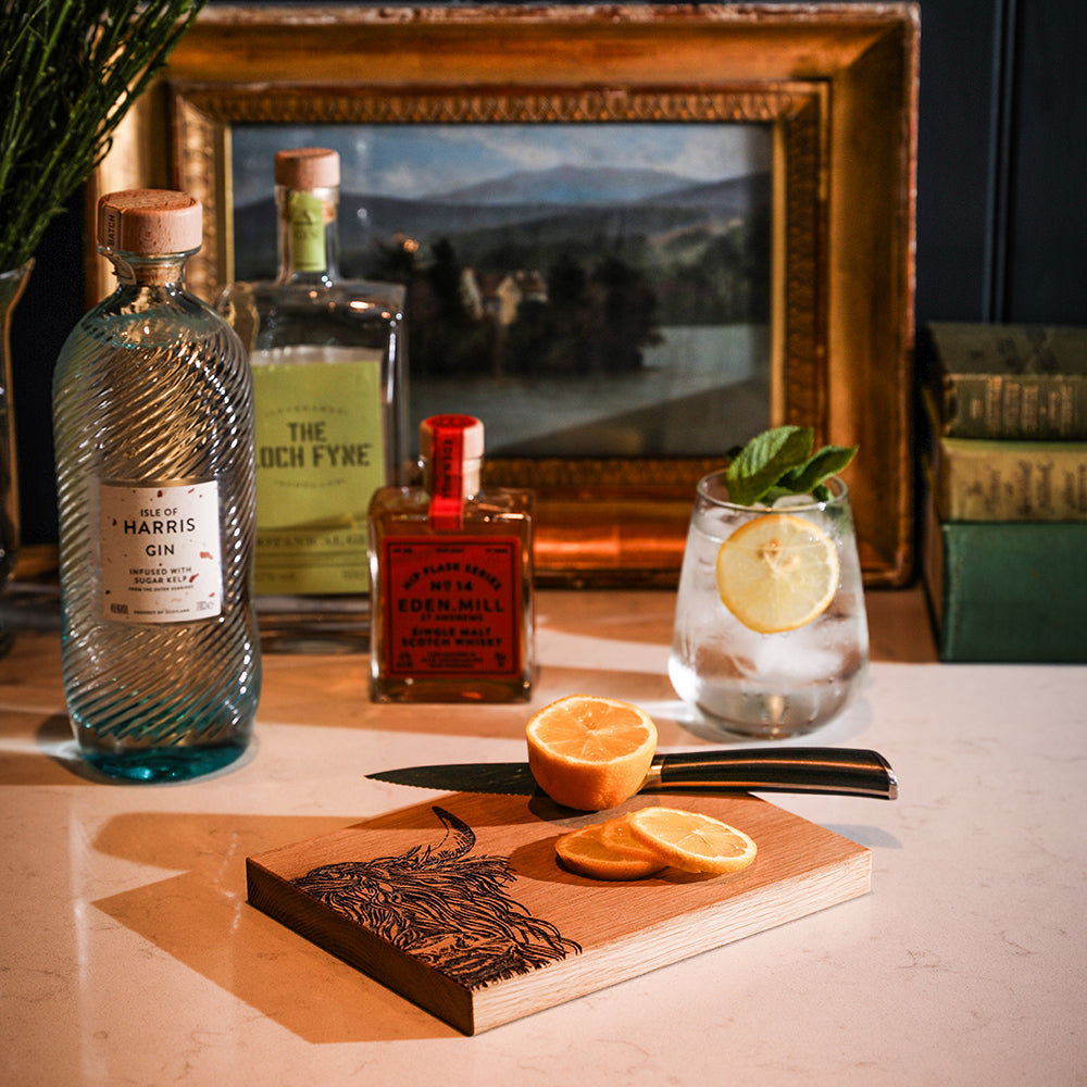 A rustic oak bar board with a detailed engraved highland cow design showcasing natural wood grain