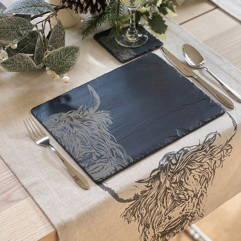 Dark gray slate place mats with intricately engraved silver highland cow design perfect for stylish table settings
