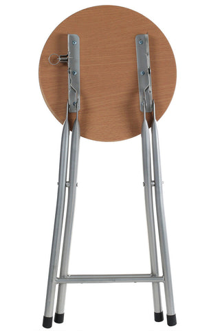 Hinata folding stool with a round wood veneer seat on a silver metal folding frame and black rubber feet