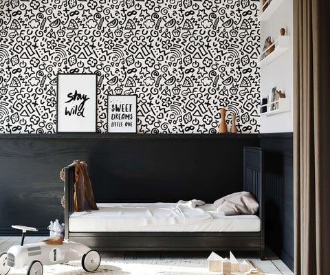Black and white doodle patterned wallpaper hip with whimsical fruits stars hearts and abstract shapes design