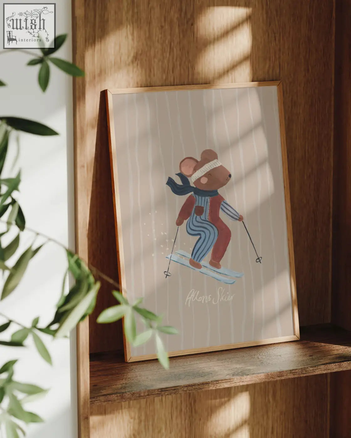 A framed art print of a brown mouse skier in red and blue striped attire from the season collection