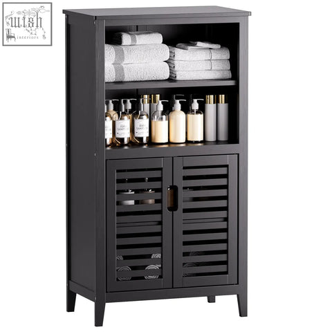 Black wooden bathroom cabinet with slatted doors and shelves holding towels in hitnet bamboo floor cabinet design