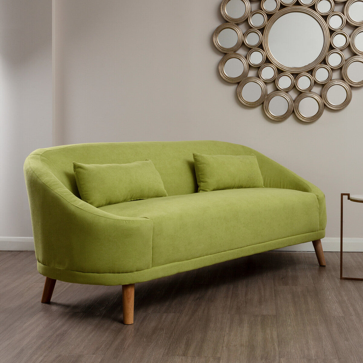 A sleek holland green linen sofa with lime-green velvet upholstery curved wooden legs and two matching cushions