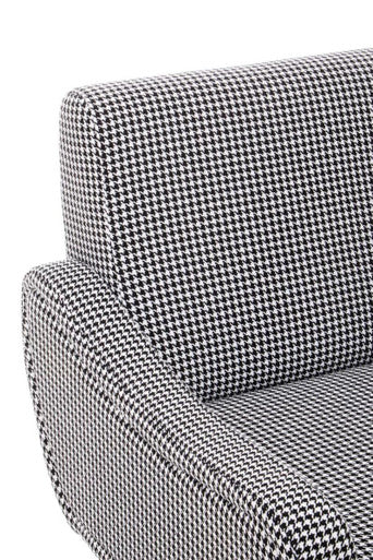 Close up of holli black and white checked armchair armrest with houndstooth fabric and gold finish legs