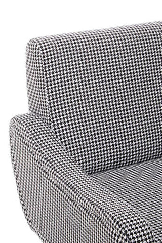 Close up of holli black and white checked armchair armrest with houndstooth fabric and gold finish legs