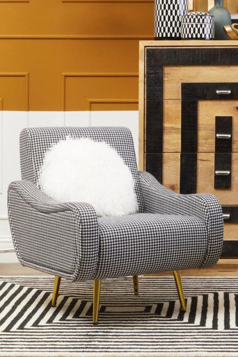 A holli black and white checked armchair with classic houndstooth fabric and sleek gold finish legs