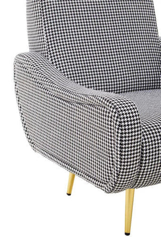 A holli black and white checked armchair with classic houndstooth fabric and gold finish legs