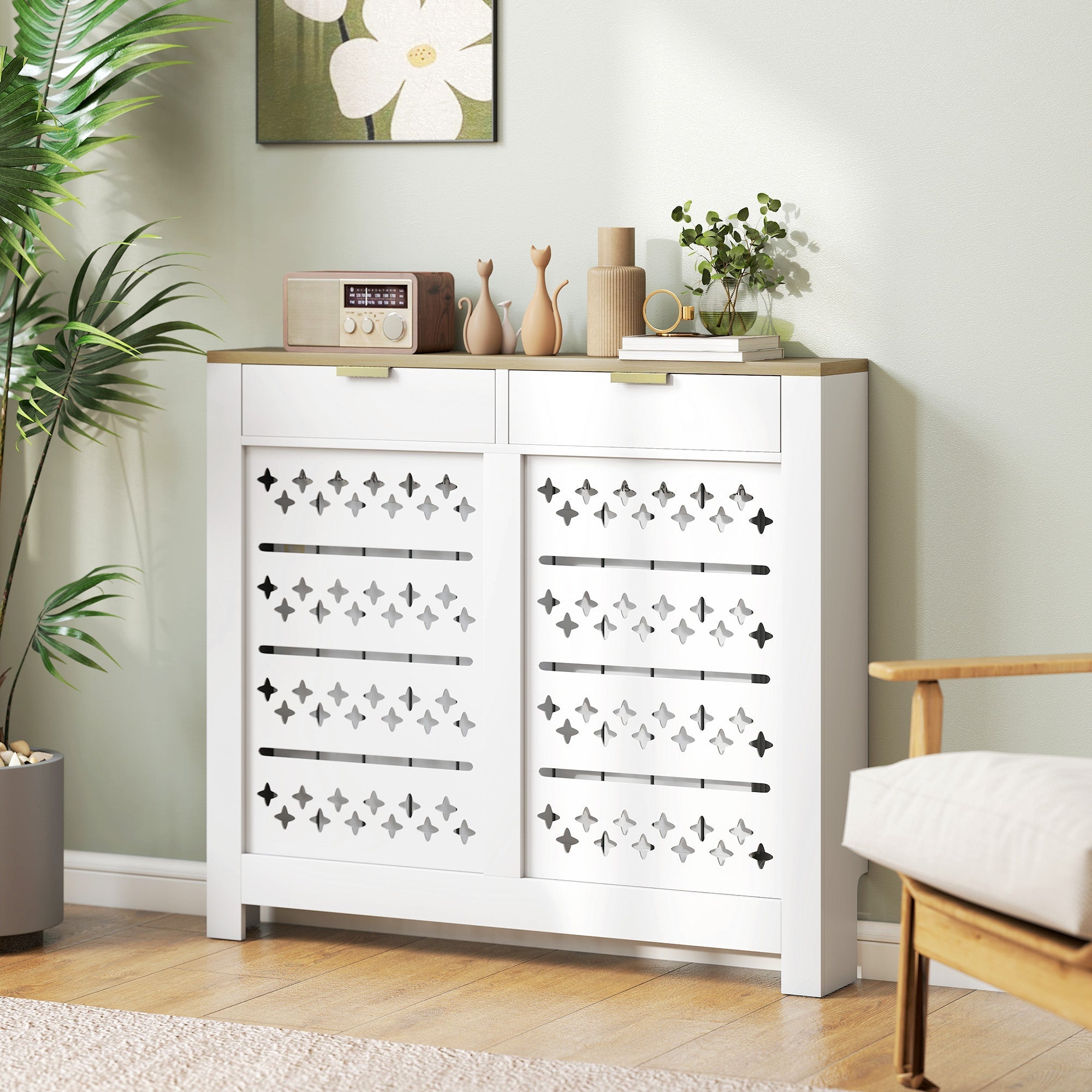 White shoe cabinet with a particle board white body, light wood top, decorative diamond cross cut-outs, and 2 drawers