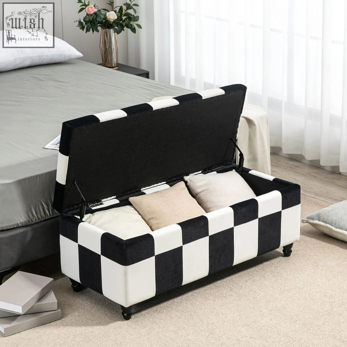 Black and white storage ottoman with velvet fabric, button tufted lid, colour block design, and wooden legs for living room
