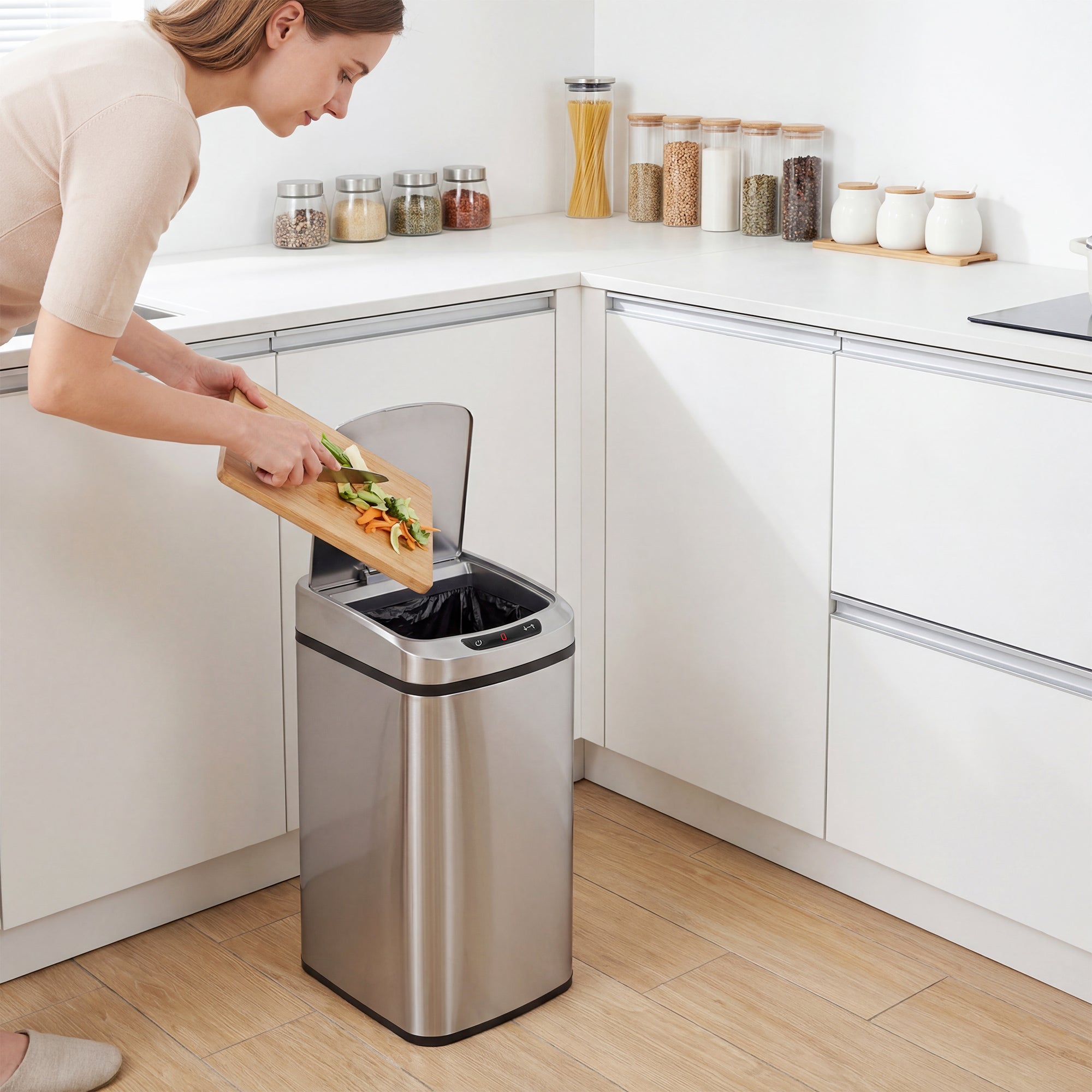 Stainless steel sensor bin with infrared sensing and manual touch button featuring a transparent lid for kitchen use