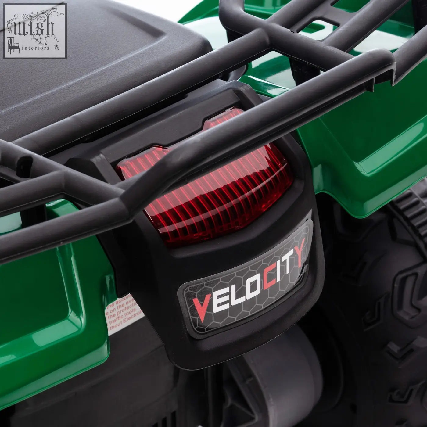 Back view of green and black homcom 12v kids quad bike with red taillight velocity branding and led headlights