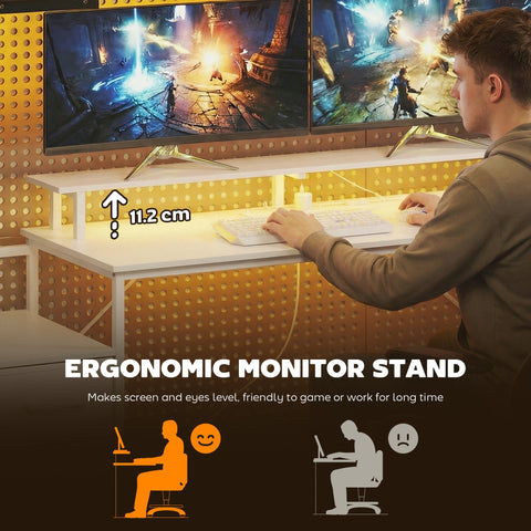 White ergonomic monitor stand with adjustable height on homcom gaming desk with charging station for home office