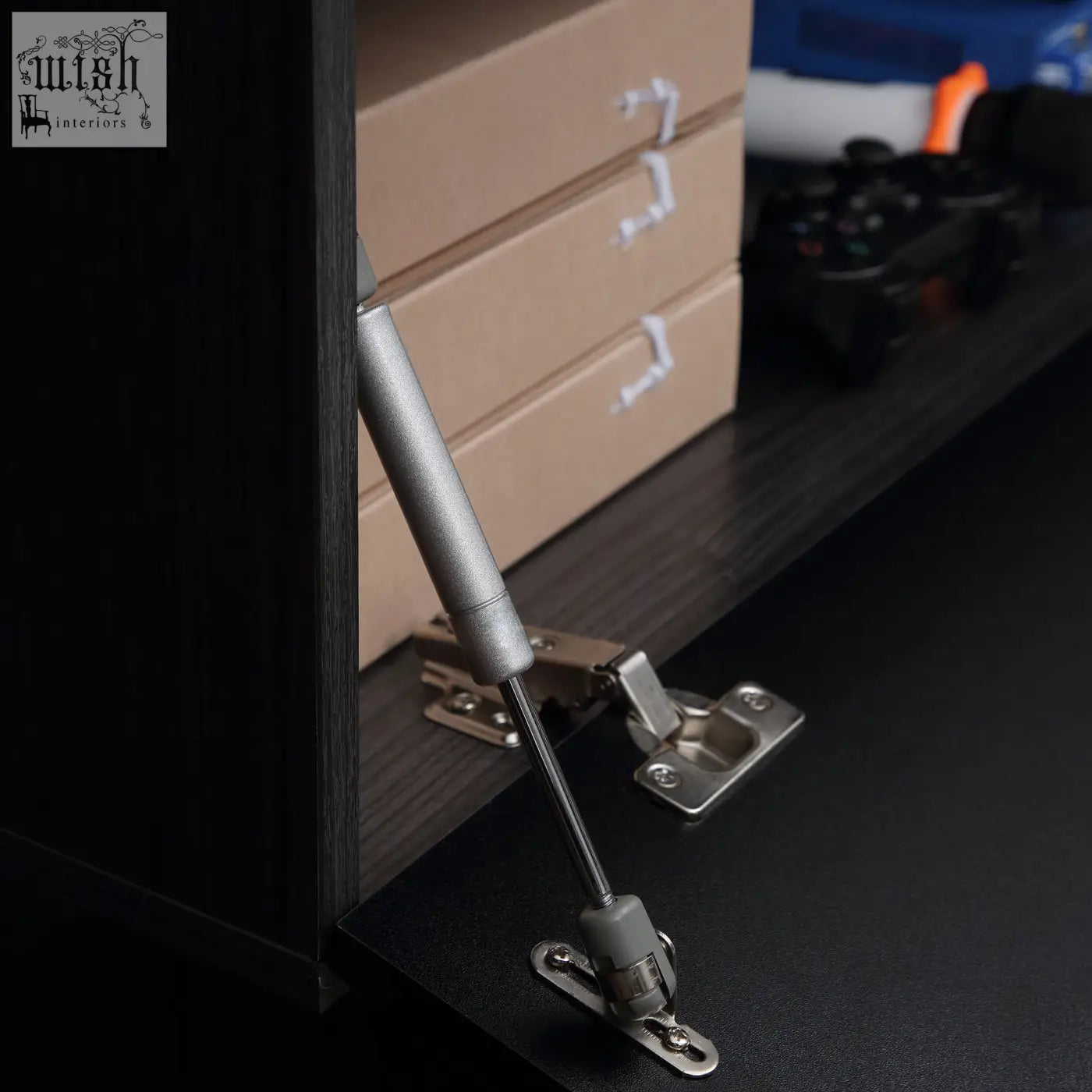 Silver finished cabinet door hinge with gas spring on grey and black high gloss particle board tv unit stand