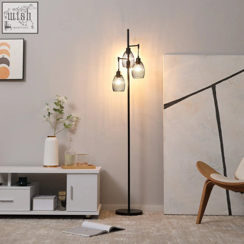 Black metal industrial floor lamp with three cage-style glass shades dimmable and max 40w for living room use