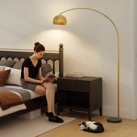 Gold tone arc floor lamp with perforated dome shade and faux black marble base for great stability