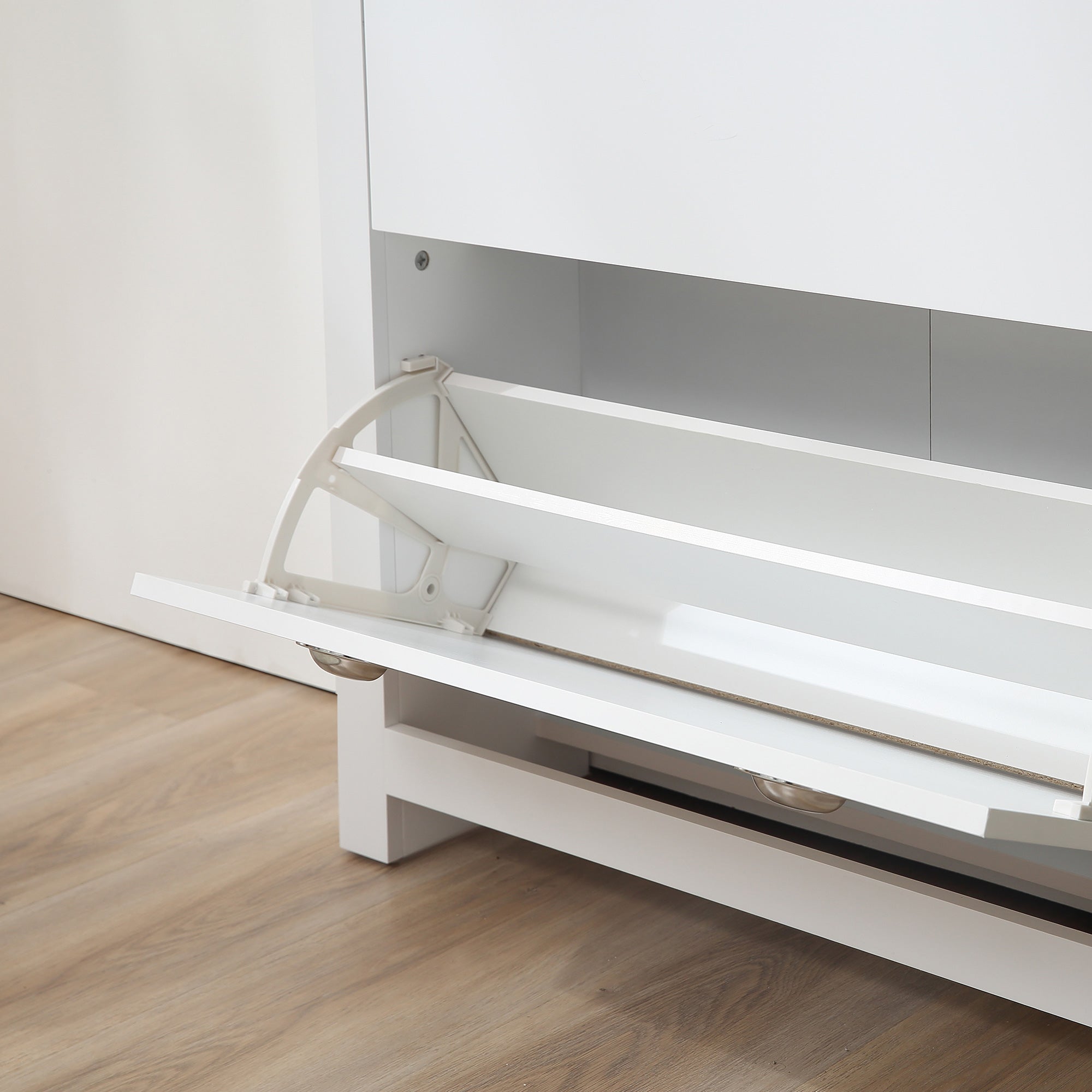 White foldable bed with sleek design and metallic hinges shown beside homcom shoe cabinet with adjustable shelf and two tipping drawers